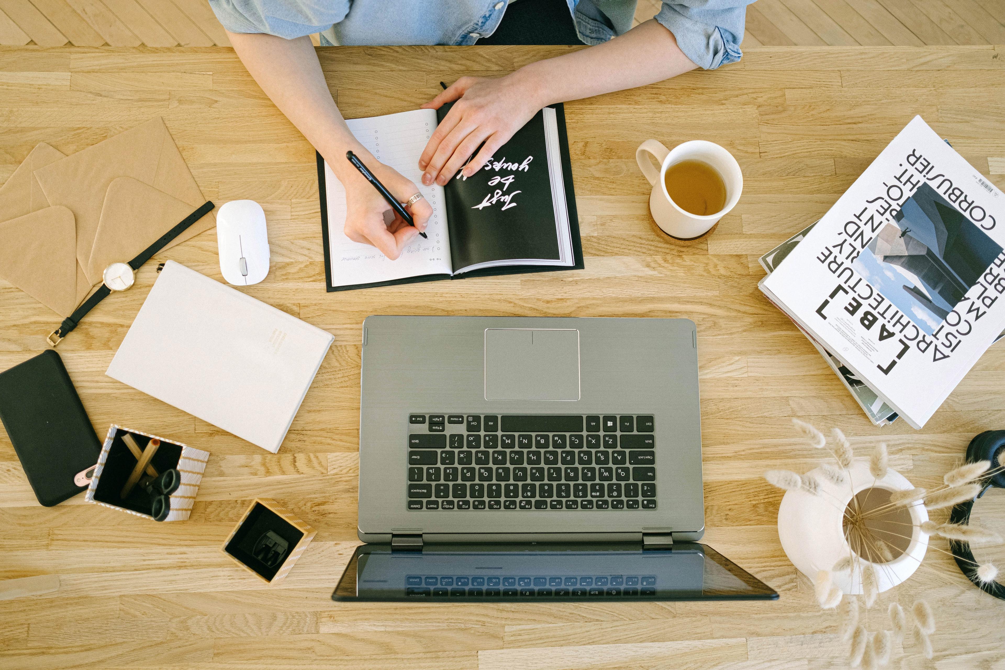 Photo by Ivan Samkov: https://www.pexels.com/photo/high-angle-view-of-woman-writing-in-notebook-4240587/